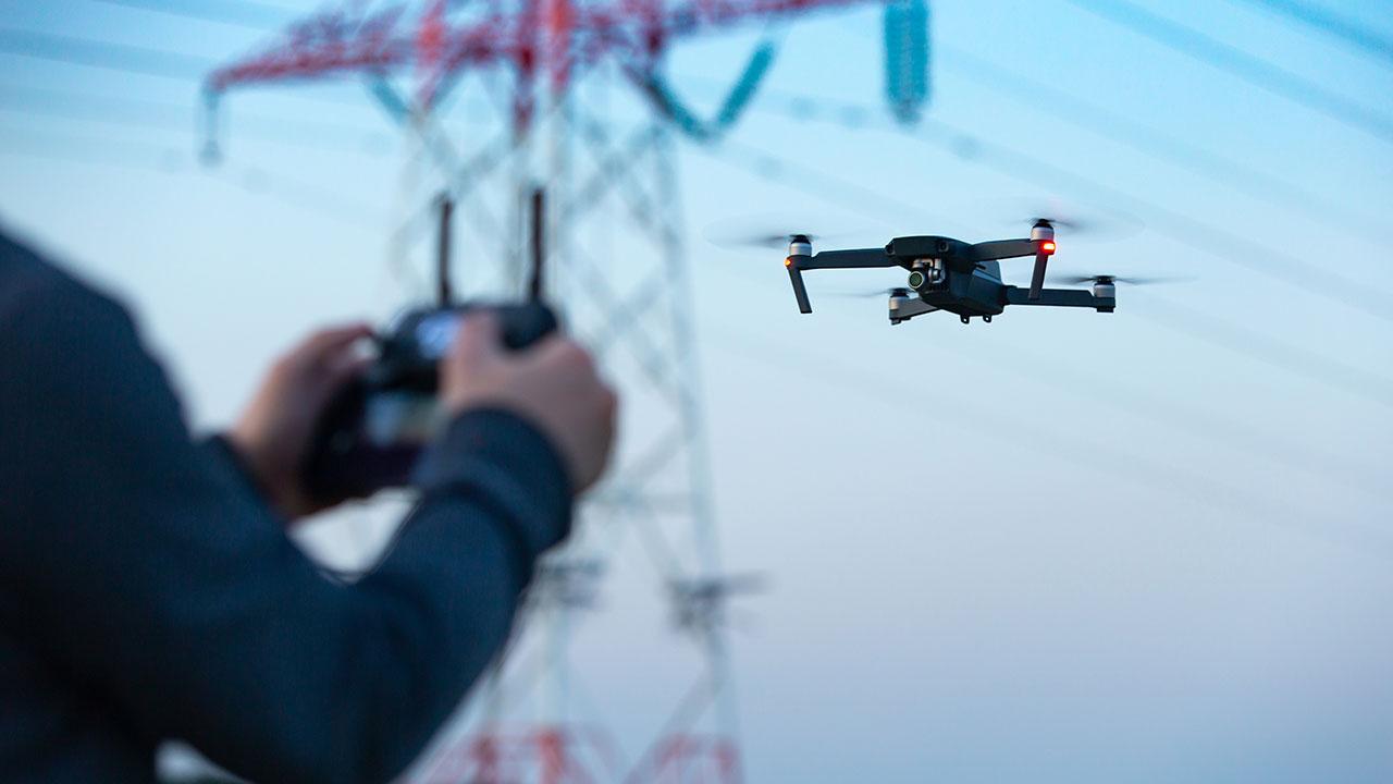 A drone remotely collects utility tower data